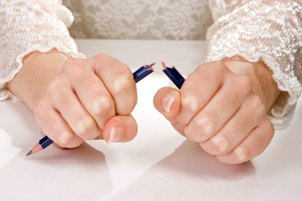 Woman snapping pencil in anger