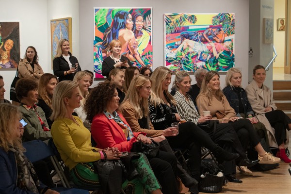 People sitting in art gallery lecture